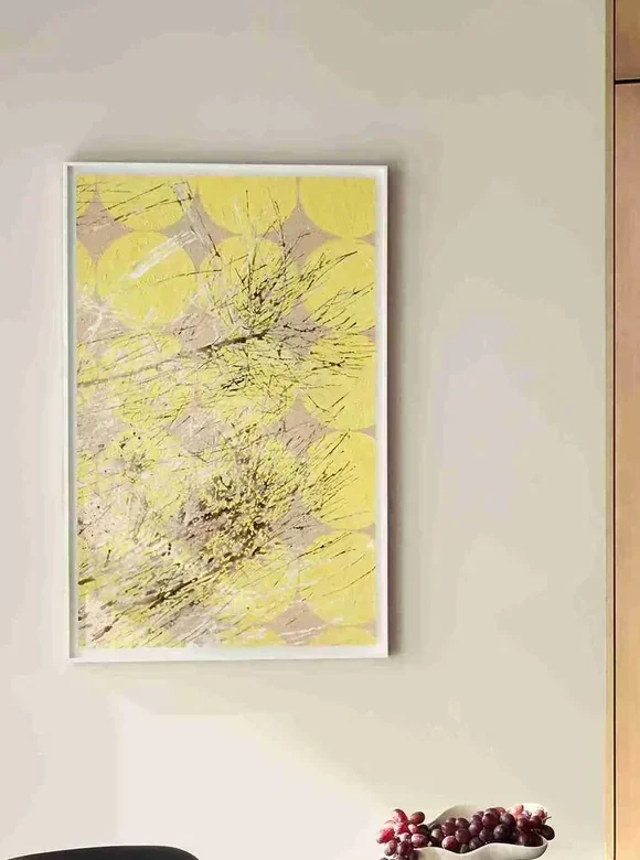 Detail of the framed abstract work in yellow and grey on the showroom wall