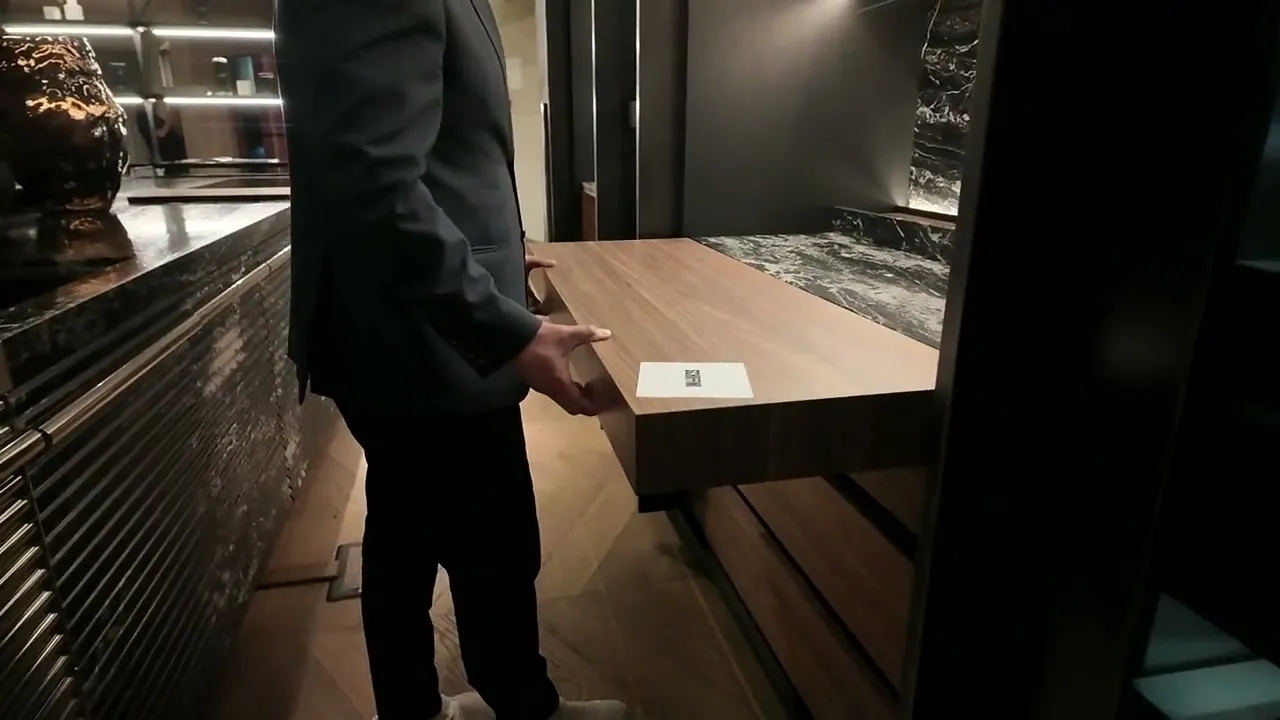 Wood-veneer table sliding out of a kitchen island