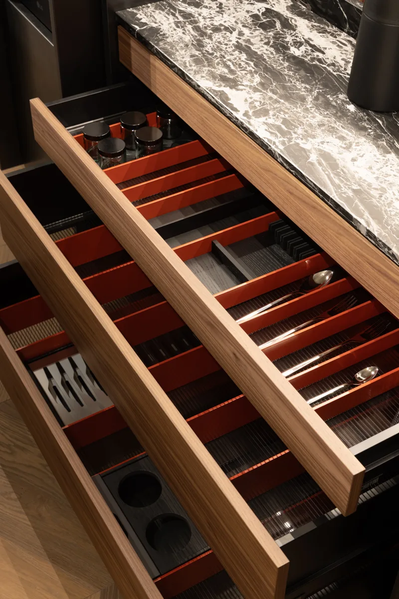 Stacked open Schiffini drawers in wood with red-lined interiors