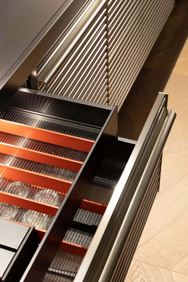 Schiffini drawers open beside fluted stainless steel fronts