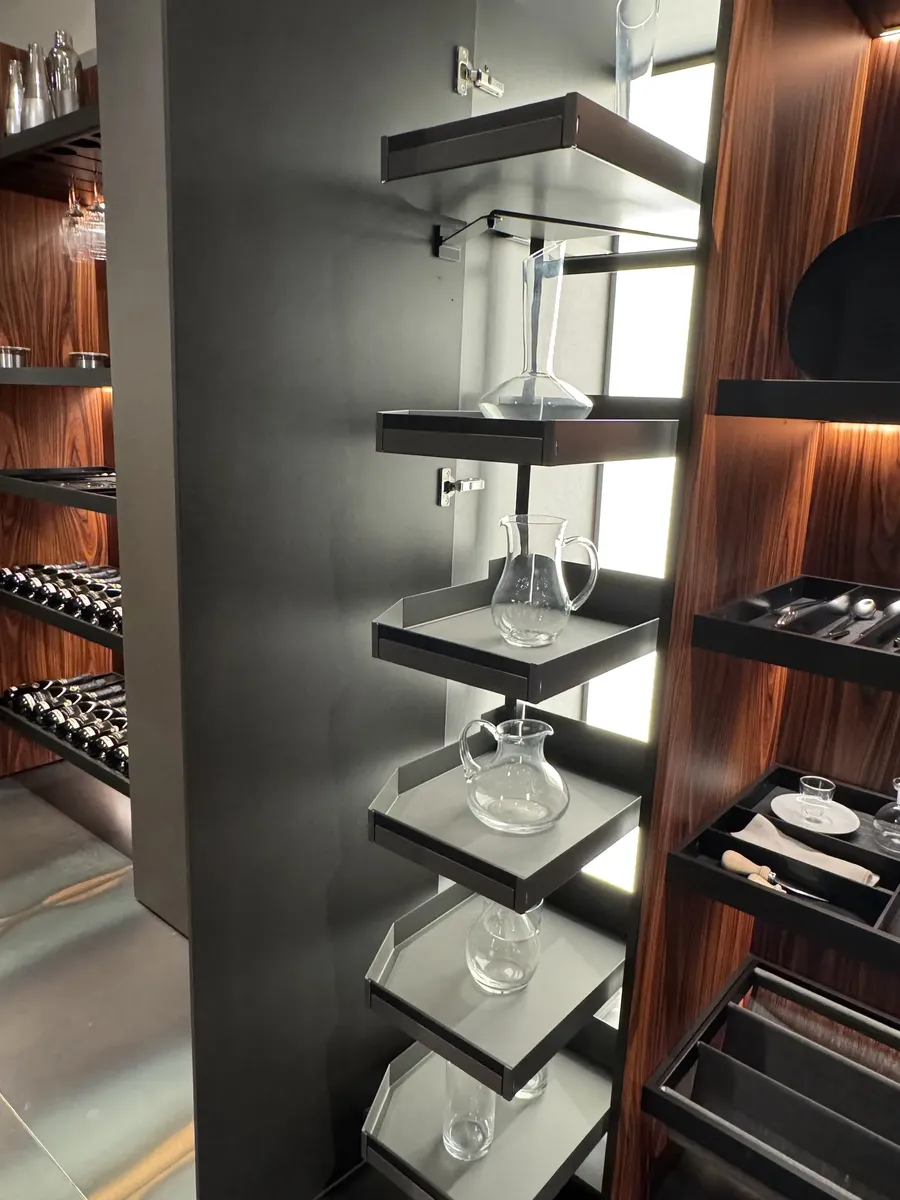 Rimmed pull-out trays holding glass carafes