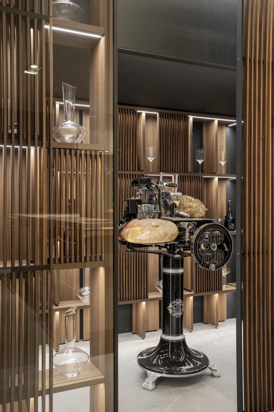 Walnut Swing shelving framing a lit collector's room with a vintage slicer
