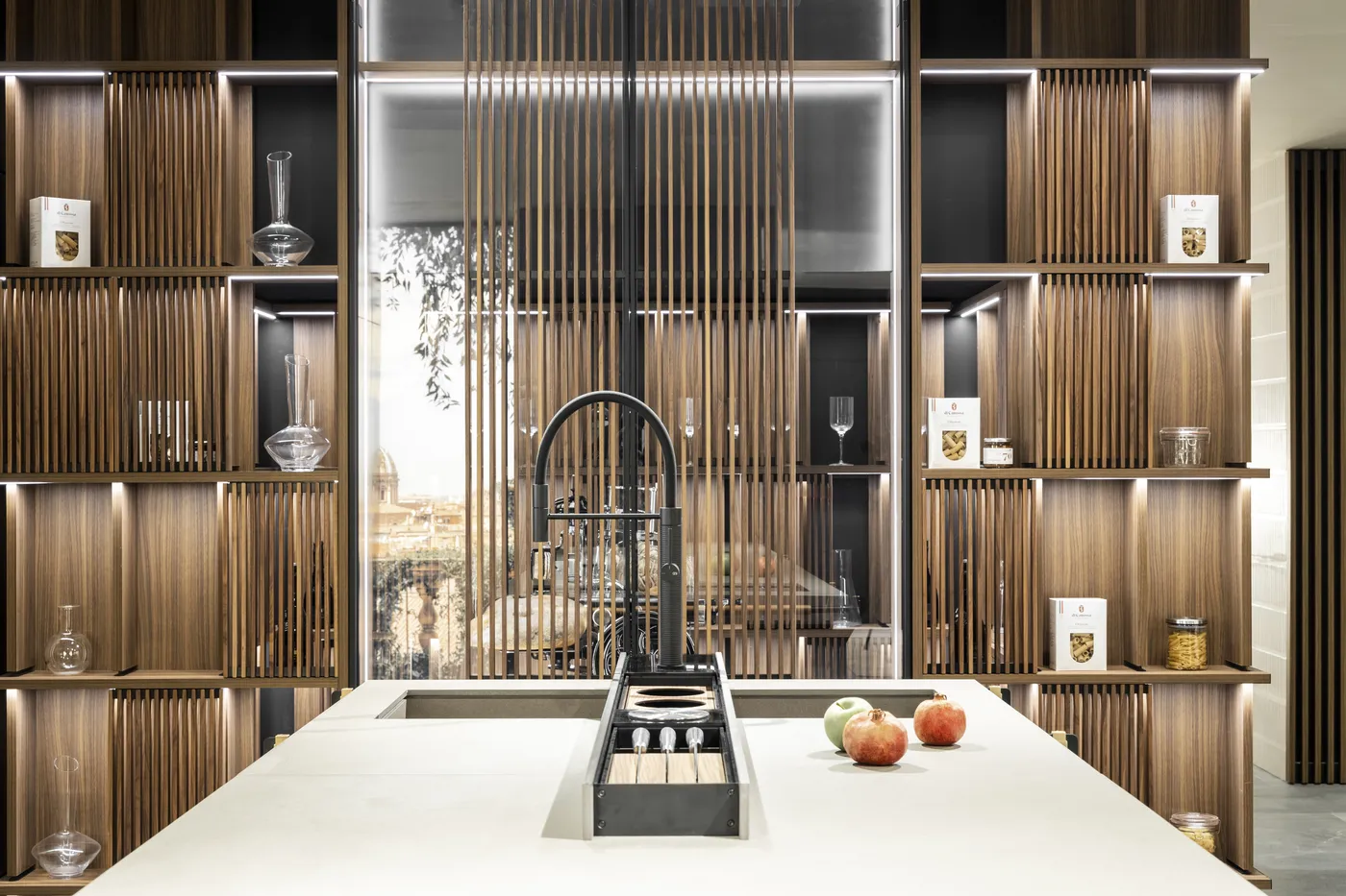 Swing display shelving with fluted walnut shutters behind a white kitchen island