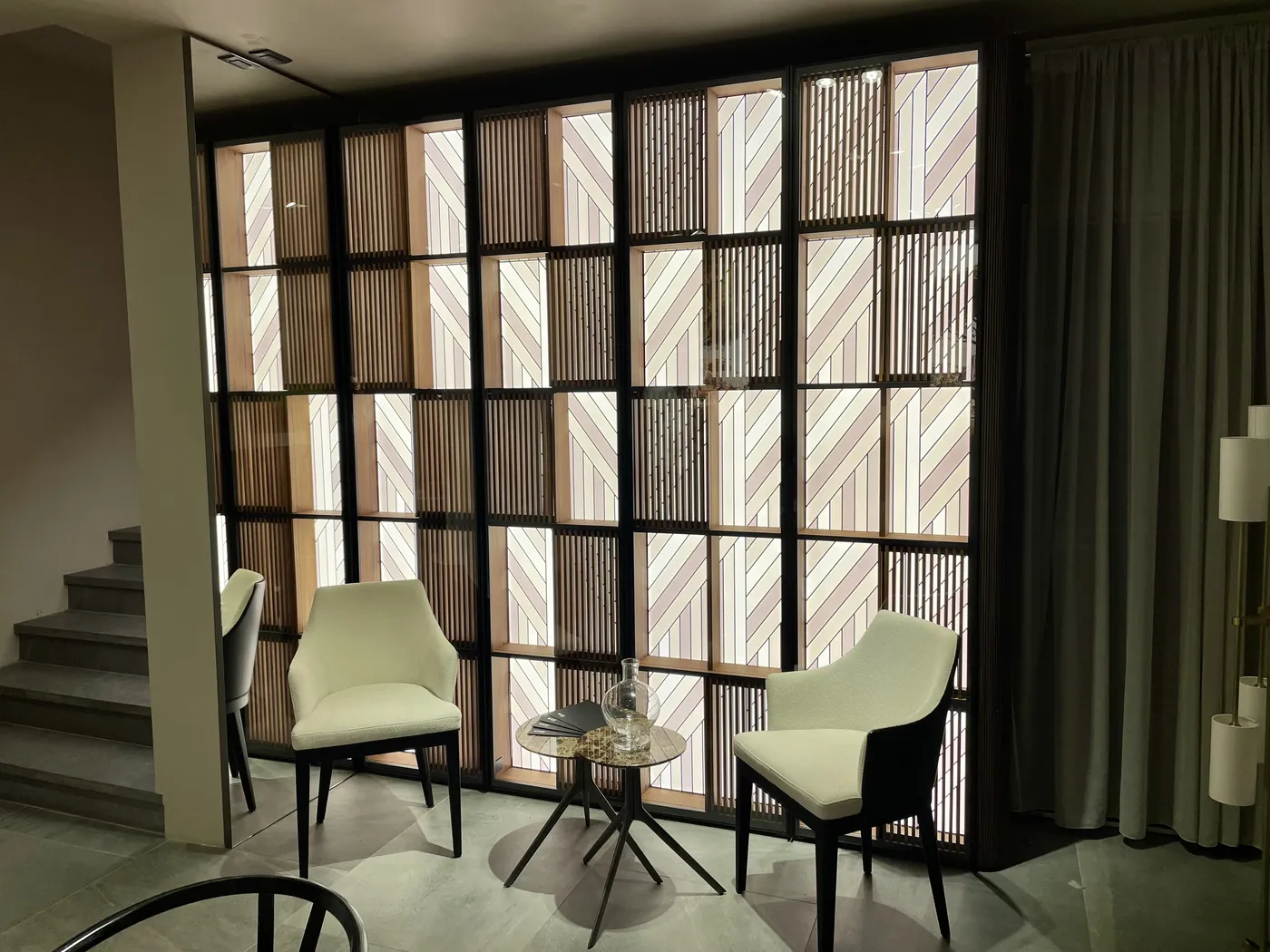 Backlit Swing wall in a black frame behind two lounge chairs