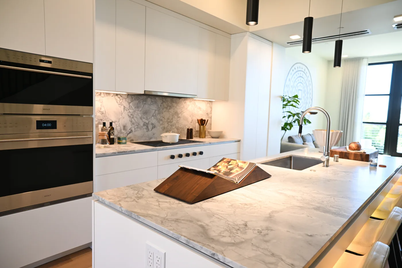 White SCIC kitchen with a stone island at Yerba Buena Island